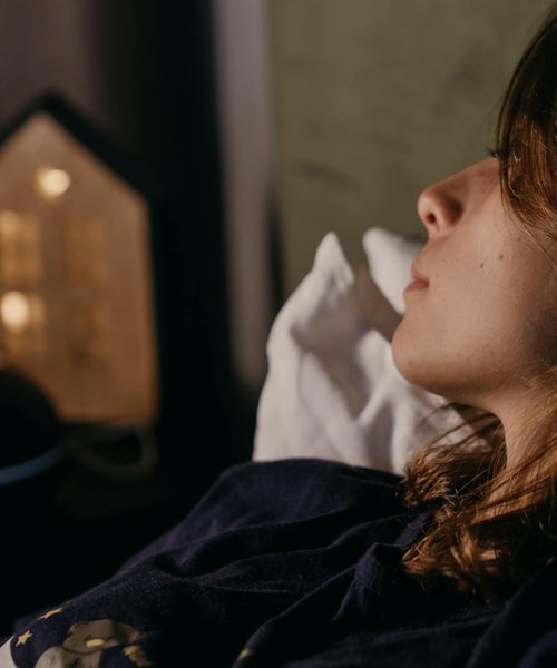 A quiet silhouette of a person in a reflective, gentle posture.